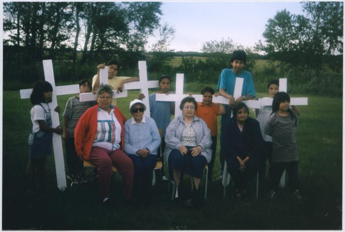 Elders &amp; children at gathering to place crosses on residential school graves.  Elders: Rosabelle McNabb, Jessie Dieter, Sarah Brass, Shirley Akapew.  Children: Tanis, Terry, Cody, Deidre, Gena, Joseph, Dakota, Jason