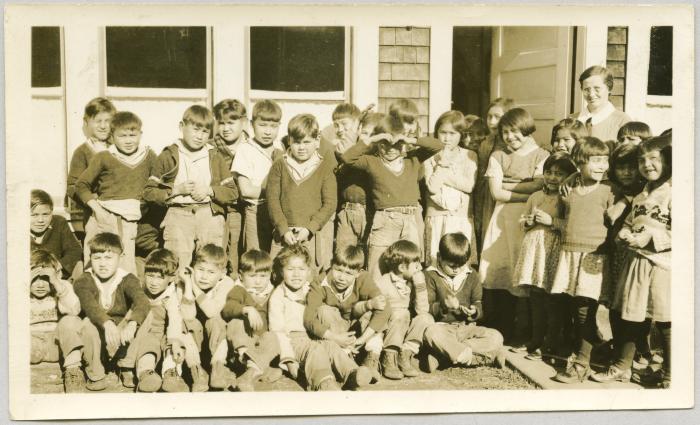 [Anne E. Copithorne with group of students in front of building.]