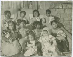 [Young pupils of the Red Deer Institute : each girl has a doll which came as presents from the east]