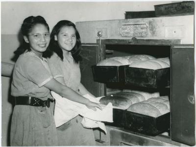 [Female students baking bread]
