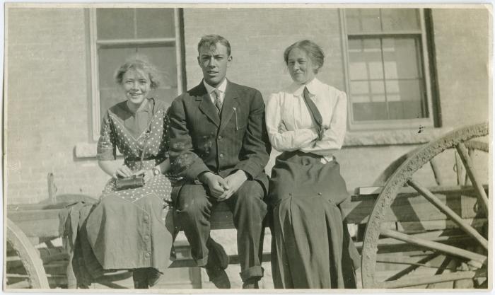 [Three staff members sitting on a fence, Brandon Institute]