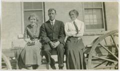 [Three staff members sitting on a fence, Brandon Institute]