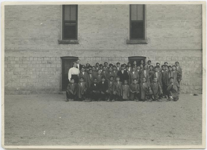 Boys with some of the staff at the Mount Elgin Indian Industrial Institute, Muncey