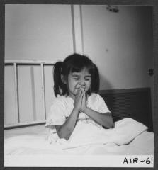 Alberni Indian Residence Alberni, B. C. Little girl saying prayers.