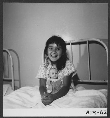 Alberni Indian Residence Alberni, B. C. Little girl in bed with doll.