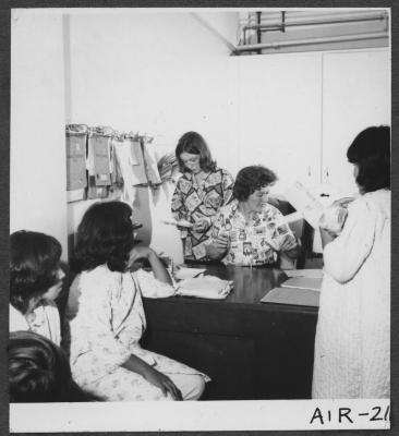 Alberni Indian Residence Alberni, B. C. Mrs. John Andrews distributing clothing to girls.