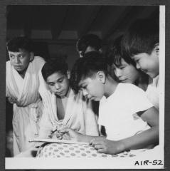 Alberni Indian Residence Alberni, B. C. Group of boys watching one boy painting.