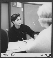 Alberni Indian Residence Alberni, B. C. E. J. Dunn School in Port Alberni. Indian boy facing camera involved with others in discussion.
