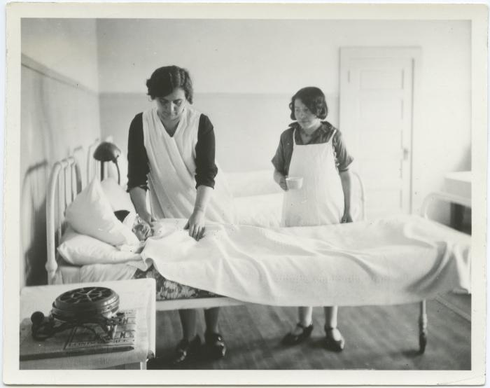 Caring for a sick laddie with Indian girl as assistant to nurse, Indian Residential School, Edmonton, Alta.