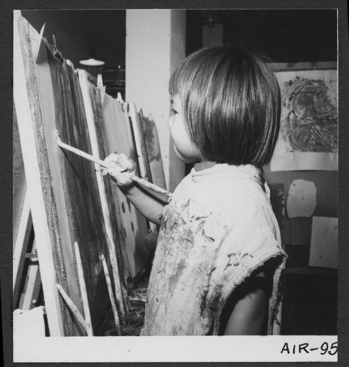 Alberni Indian Residence Alberni, B. C. Small girl painting in kindergarten at Residence.