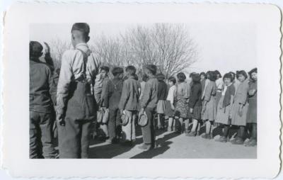 Indian children at flag raising at beginning of every school day, Round Lake, Sask.