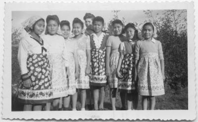 Girls at the Crosby Girls' School wearing aprons sent from Beaver Band Club of Trail, B.C.