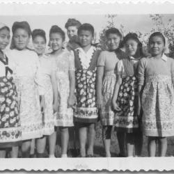 Girls at the Crosby Girls' School wearing aprons sent from Beaver Band Club of Trail, B.C.