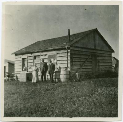 Rev. and Mrs. Egerton Ryerson Steinhauer with the Superintendent of Indian Missions in front of the old school house, Morley, Alta.