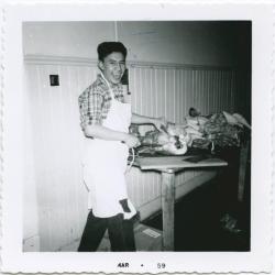 Portage Residential 1959 [Male student carving turkey].