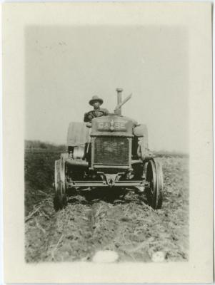 John Steinhauer ploughing with the tractor, Indian Residential School, Edmonton
