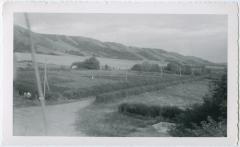 Road leading out from the school to the Principal's Residence with the Qu'Appelle hills in the background, Round Lake, Sask.