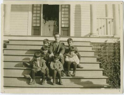 The preacher and the W.M.S. Home boys on the steps of the Home, Kitimaat