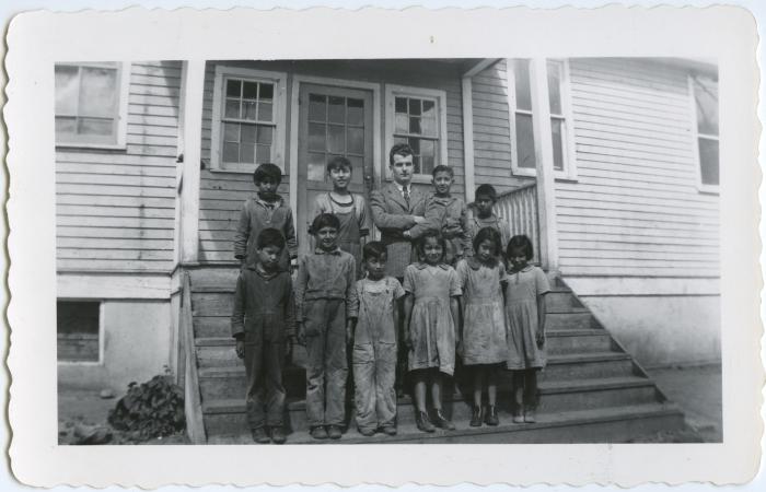 Some of the Indian children on the school steps with Alan Bell who was in the advanced room the first year I was at Round Lake, Sask.