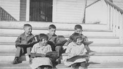 Five children sitting on the steps