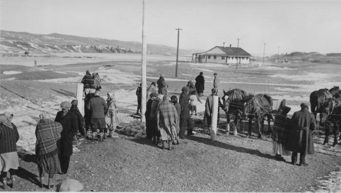 Winter scene after church, Bow River, Morley, Alberta. "White" School across from church, Stoney Indians visiting after church.
