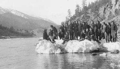 Lytton, B.C. - Group of St. George's students standing on beached ice blocks, at edge of Lytton Creek