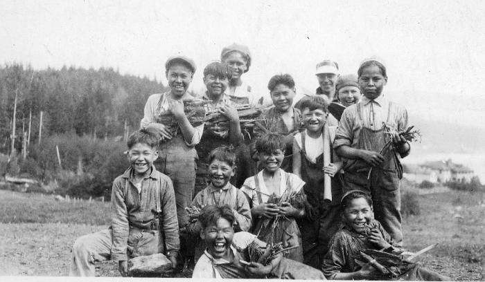 School Boys from Industrial School, Alert Bay, BC.  Written on back of picture, "Show me a group of whites who take their work as seriously as these.  All land clearing at the school is done by hand.  Here are some of the force".