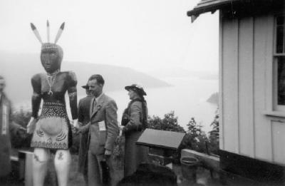 Adults and a Totem Pole