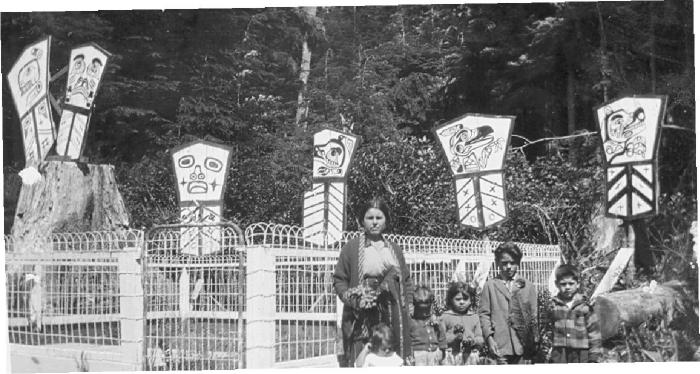 Indian family beside father's grave, Village Island, BC