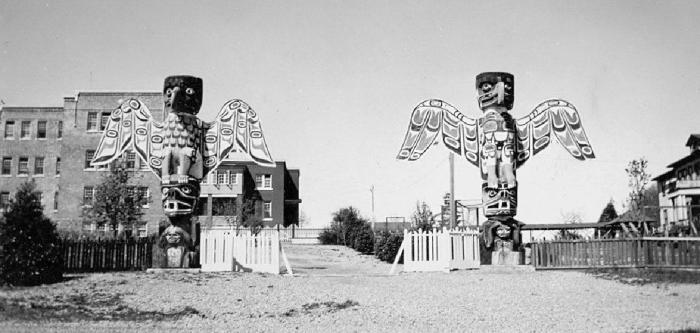 St. Michael's Residential School, Alert Bay, B.C. - Totem poles at entrance gate.