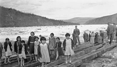 Little girls from St. Paul's Hostel watching the ice go down the Yukon River at Dawson, YT