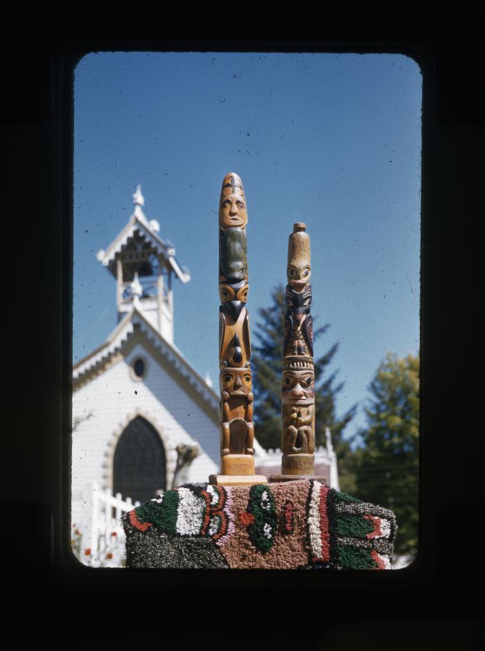 [Two totems on a decorated base.]