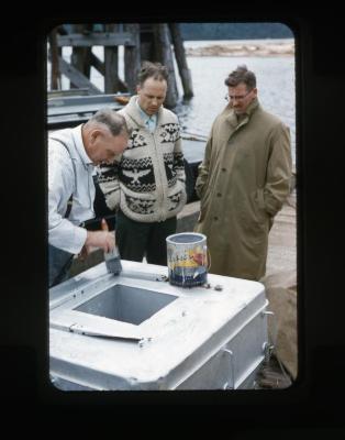 [A Man Painting, while Other Look on]