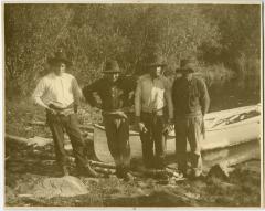 Four Cree Indian guides with their canoe, Norway House, Man.