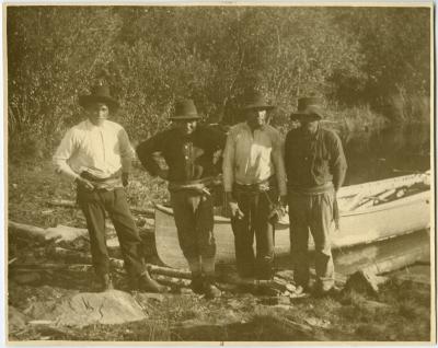 Four Cree Indian guides with their canoe, Norway House, Man.