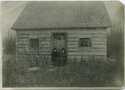 Norway House jail on Jail Island : two government nurses sitting on steps