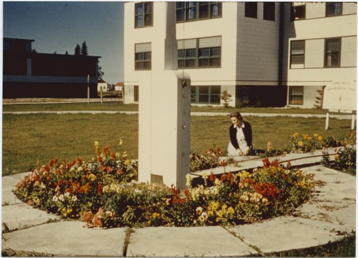 Flag pole base. Day School block at left.