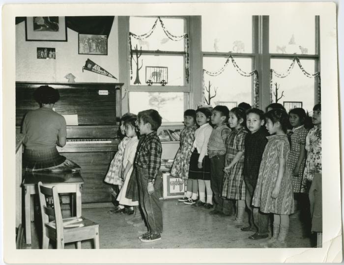 [Children performing a song with actions, Norway House Indian Residential School, Man.]