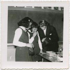 Stephanie Tainoski helping two of the girls in her group to make felt handbags, Norway House