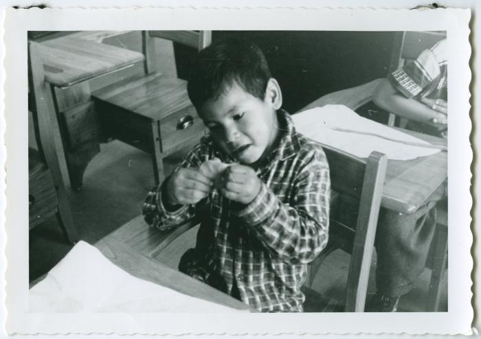 [Student shaping his play dough : art class at Norway House Indian Residential School]