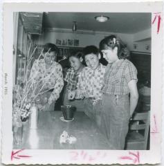 [Four students in a classroom at the Indian Residential School, Norway House]