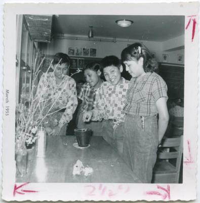 [Four students in a classroom at the Indian Residential School, Norway House]