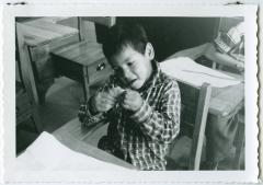 [Student shaping his play dough : art class at Norway House Indian Residential School]