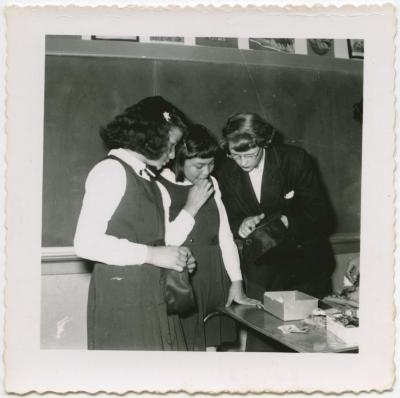 Stephanie Tainoski helping two of the girls in her group to make felt handbags, Norway House
