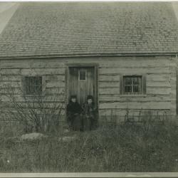 Norway House jail on Jail Island : two government nurses sitting on steps