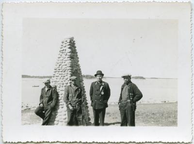 [Chief John Monais and three other Indians standing beside the James Evans memorial cairn, Norway House]