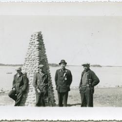 [Chief John Monais and three other Indians standing beside the James Evans memorial cairn, Norway House]