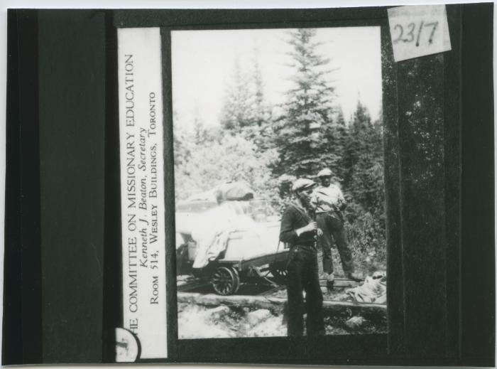 [Between Norway House and Oxford House, a distance of some two hundred miles, there were many portages, some as long as three miles : on this particular portage, there was a railroad track :  goods were loaded on to a small car which then had to be pulled : since there were no bridges one had to hold back just as hard going down hill as [one] had to pull going up]