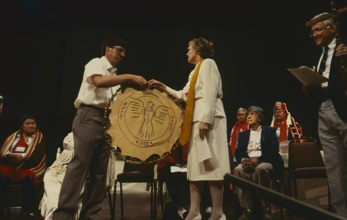 Anne Squire receiving from Alf Dumont gift for the United Church of Canada from ANCC, presented to her after the constitution of the ANCC and covenanting service.