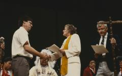 Anne Squire shaking hands with Alf Dumont on platform, after the constitution of ANCC and covenanting service, at the 32nd General Council